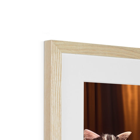 A cat peering through a picture frame in front of a wood and leather backdrop.