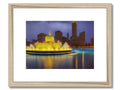 A framed photograph of Chicago with a skyline behind it on a white background.