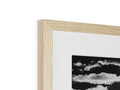 A white photo inside of a wooden picture frame in the shape of a pinhole.