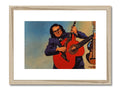 There is a picture of a musician with a guitar in a wooden frame.