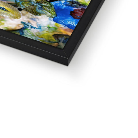 A large picture frame with artwork on top of  a monitor