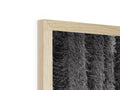 A headboard with a wood frame, the back of it has a wooden side of