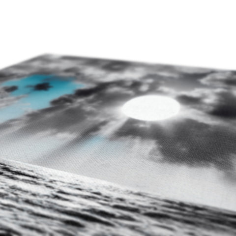 Paper that is imprinted in a pillow cover with moonlit skies overlooking the ocean.