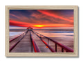 A picture of a view of a sunset in a colorful backdrop on a wood frame.