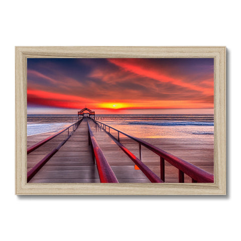 A picture of a view of a sunset in a colorful backdrop on a wood frame.