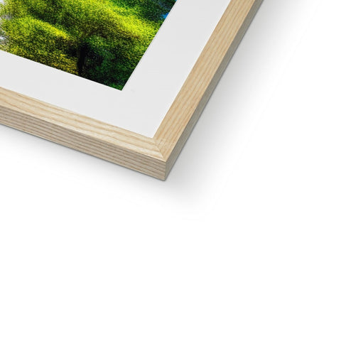 a wooden frame filled with a white picture taken at sunset with a green picture