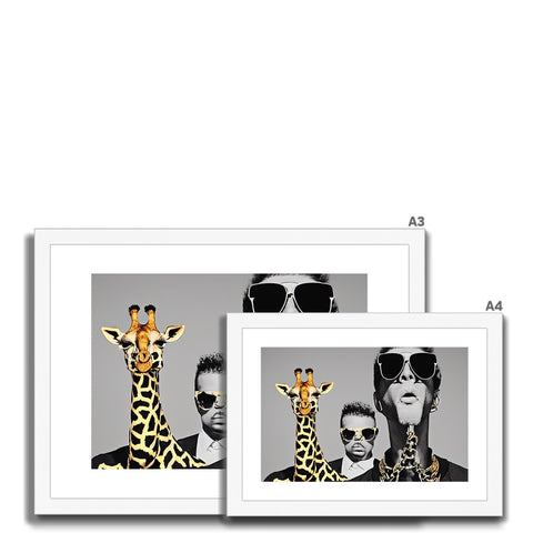 A three giraffe standing looking at a photo frame with a giraffe and people on