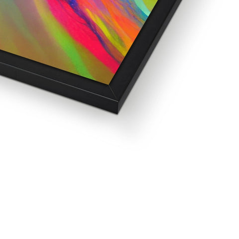 A colorful picture frame with a computer and a tablet sitting next to it.