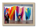A man standing in front of a wall of different art on white canvas with colorful print