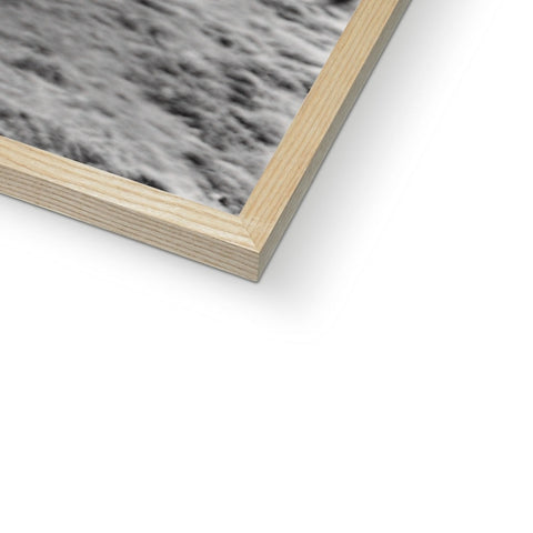 A picture frame with a photo on a wooden wall with some textured wood and a