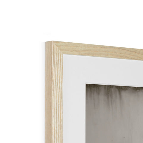A white picture frame sits in a corner on a wall.