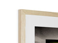 A close up picture of a wooden frame with a piece of art in a frame on