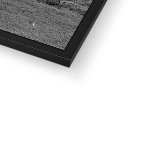 A frame of an image on a monitor lying next to a small box of photographs.