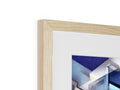 A blue framed photo is on the wooden frame with a framed image on it.