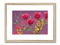 A lot of pink roses and some yellow flowers and an artistic art print hanging on a