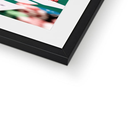 A picture is in a frame attached to a black and white picture frame with green background