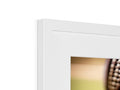 a close up of a pair of photo frames framed on a wall