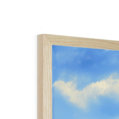 A wooden photo frame with a picture of a cloud on it in the background.