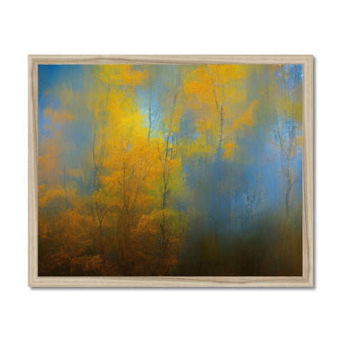 A large picture frame with a sunset image of trees near a blue wall.