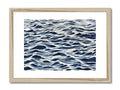 A wooden print with a white ocean wave crashing against a blue background.