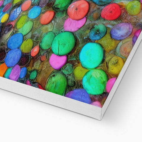 A piece of colorful art printed on a wood table covered with glass and a glass.