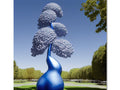 a blue  topiary with a blue sunlit painting on a blue tree beside a