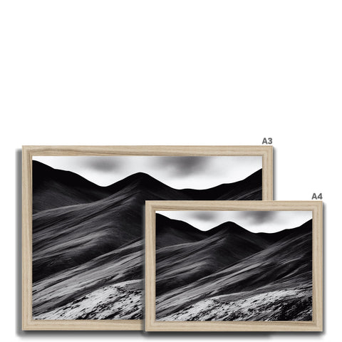 Three pictures of mountains with the mountains above them in a silver frame.