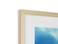 A picture frame on a white wall with wooden frame on top of it.