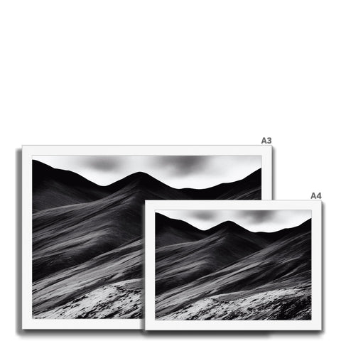 Four images on a black glass and white picture board at top of a mountain.
