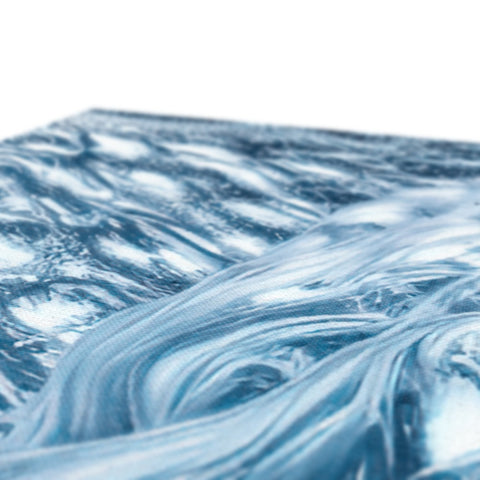 A glass plate of ice topped with water waves sitting next to a bed.