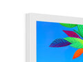 There is a picture of a painting and colorful leaves on a computer monitor.