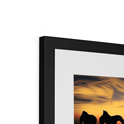 A picture frame with a black photo with a framed photograph and a picture of a horse
