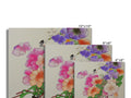 There is a large colorful card on white white wooden wall with several flowers.
