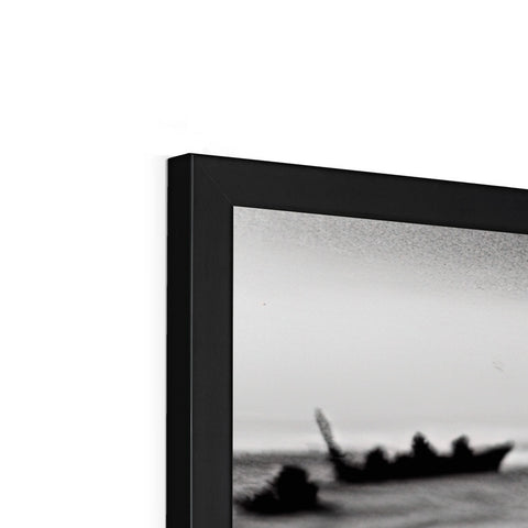 A picture frame with different kinds of black and white photos of a white television.