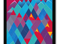 A colorful art print of the mountain peaks laying on top of a quilt with an
