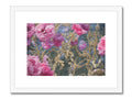 Art print featuring a few pink flowers on a wall.