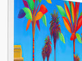 An art print with a palm tree at a tropical beach behind a fountain.