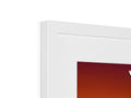 A clock is sitting next to a picture frame filled with white pixels of the macOS