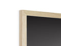 An empty picture frame on top of a small wooden frame next to a mirror.