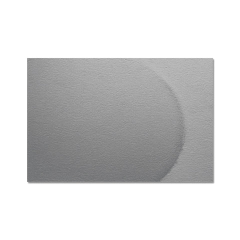 A pinhole hole punch in a white plastic card on a small red envelope.