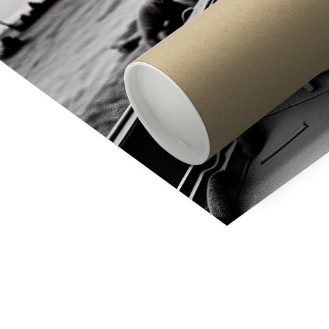 Paper roll laying on the table next to a picture of a toilet.