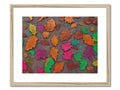 A picture of fall leaves on a piece of fabric covered with colored wallpaper.