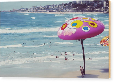An art print of a surfboard floating on the ocean with a beach in the background