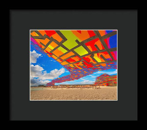 Kite on a Beach Beneath a Vibrant Umbrella - Framed Print