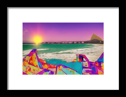 A view of the ocean and a colorful photograph that is framed out with a rock out