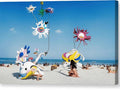 An octopus kite with people at the beach on the side