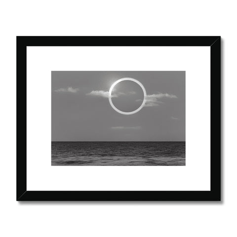 An art print of a black and white full moon lit up over a moonlit ocean