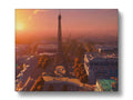a postcard with a picture of the Eiffel tower standing under a sunset