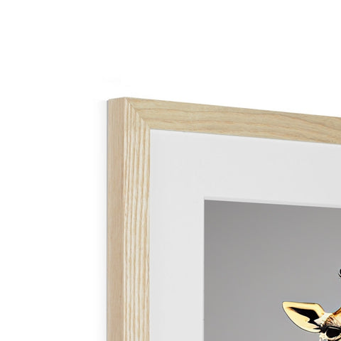 a white picture frames with a bird in it hanging from a wall