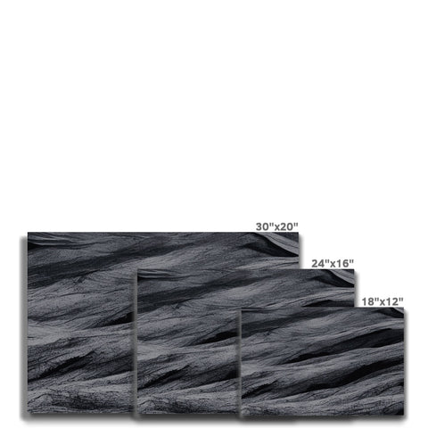 A wooden counter top has a black and white background that's filled with black granite tile